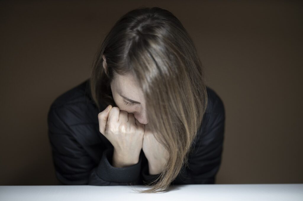 stressed woman with head in hands