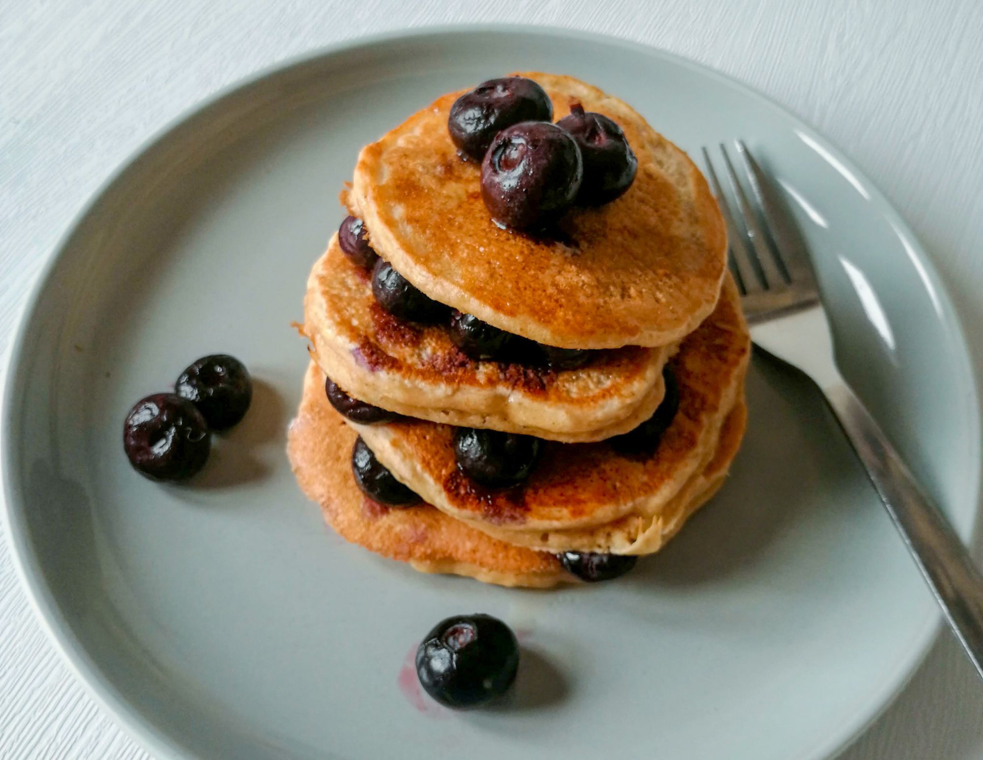 Apple & Peanut Butter Pancakes topped with blueberries